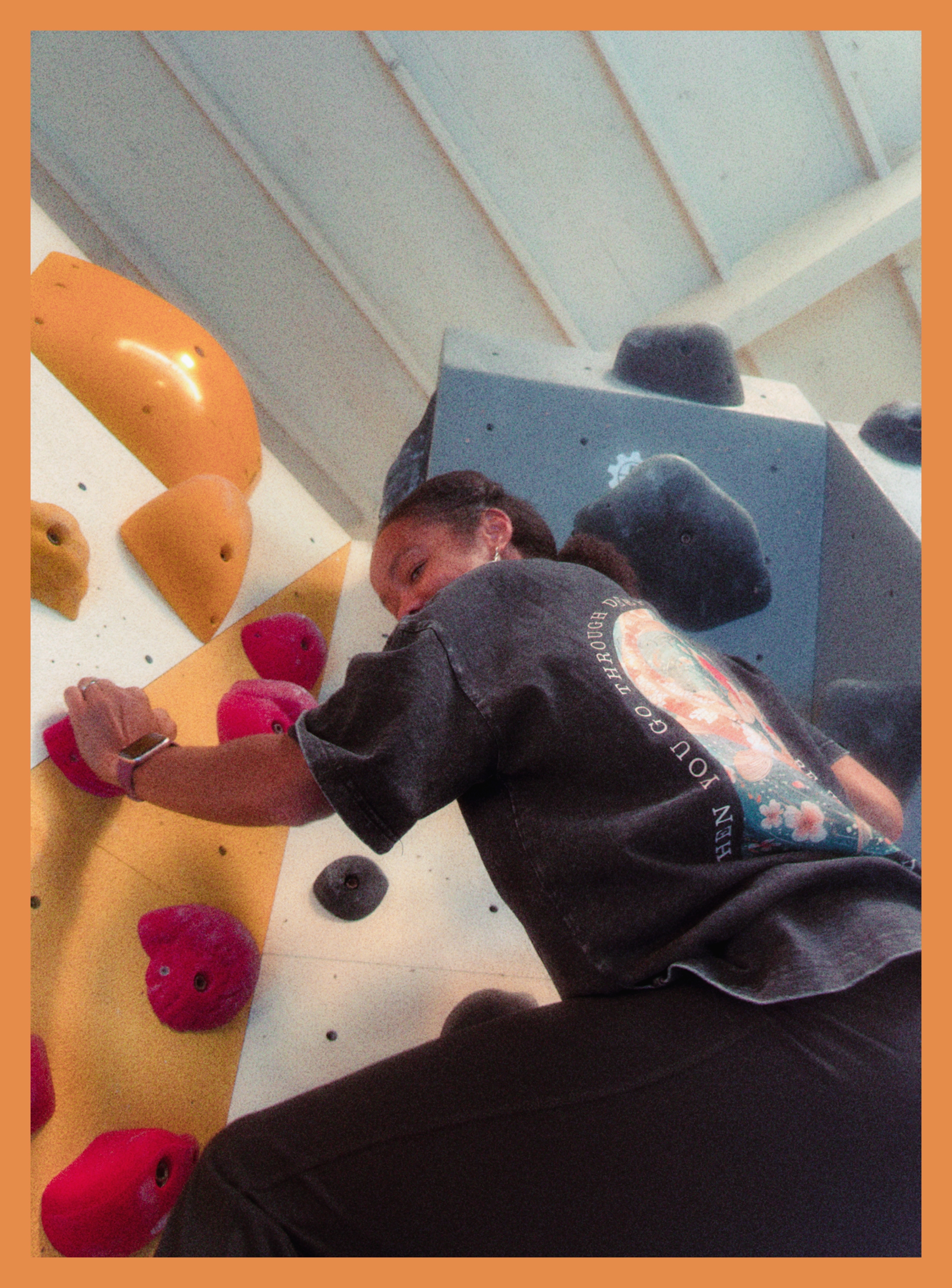 Lakeisha smirking while rock-climbing