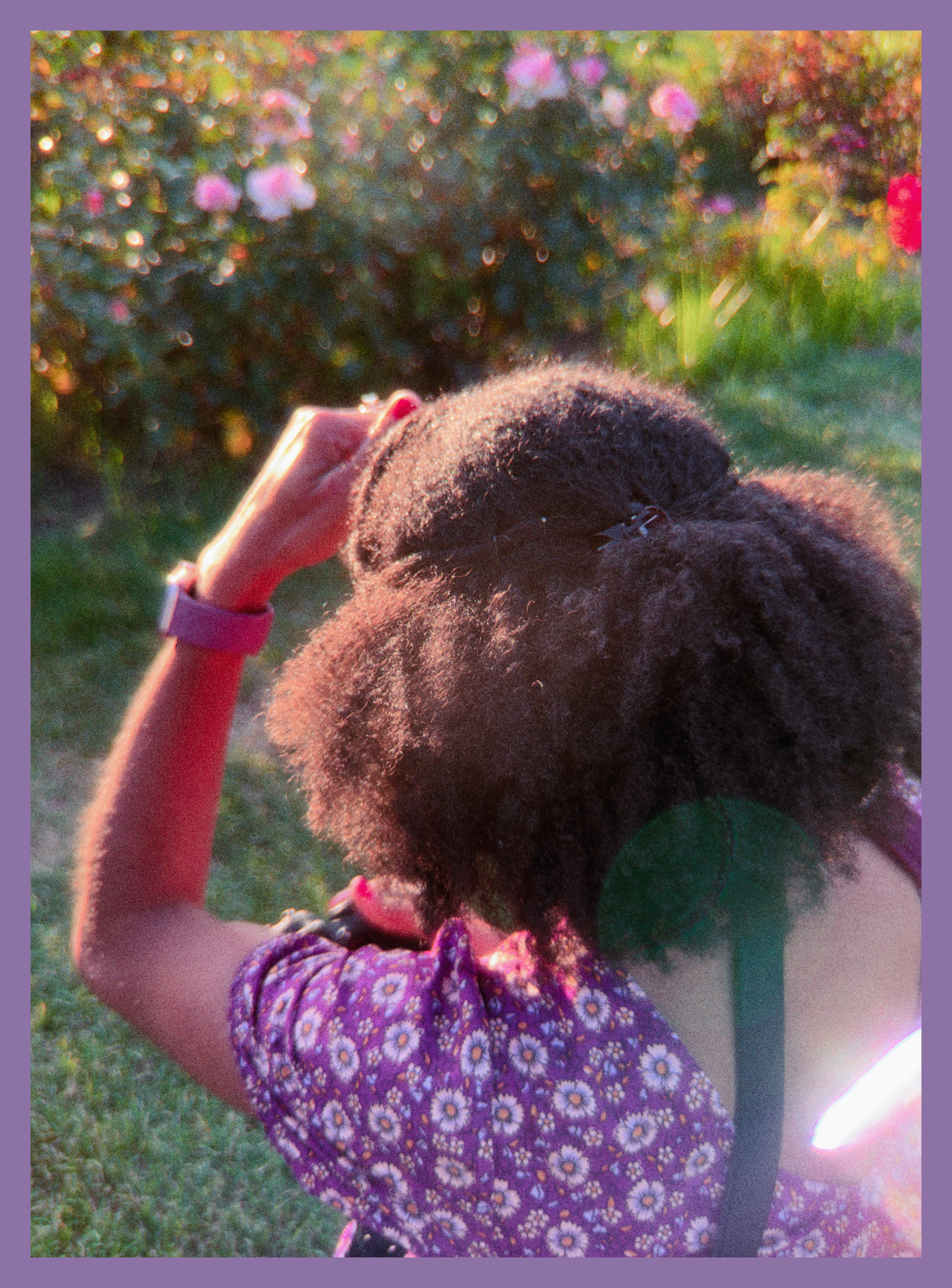 Lakeisha taking pictures of flowers
