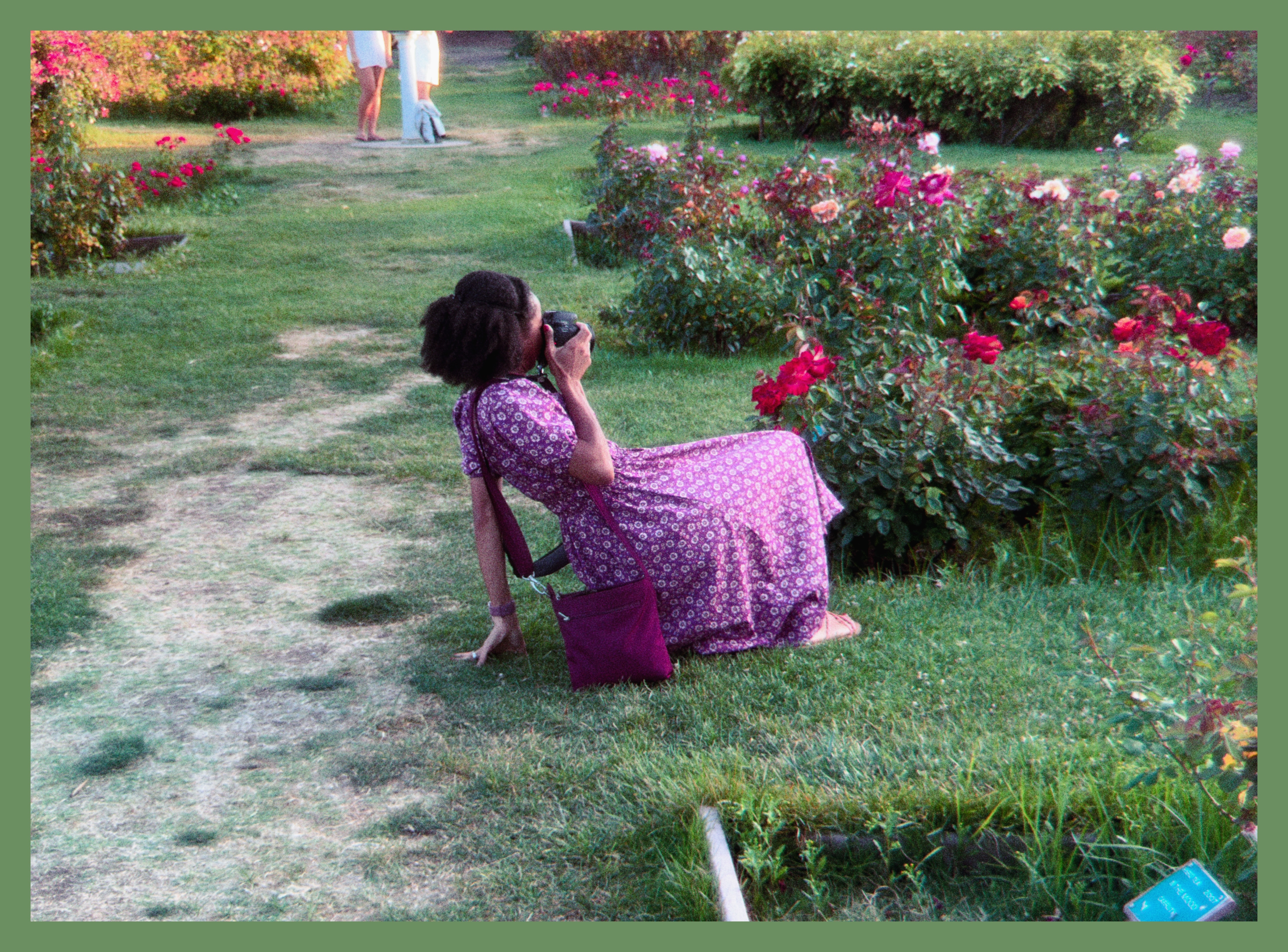 Lakeisha taking pictures of flowers