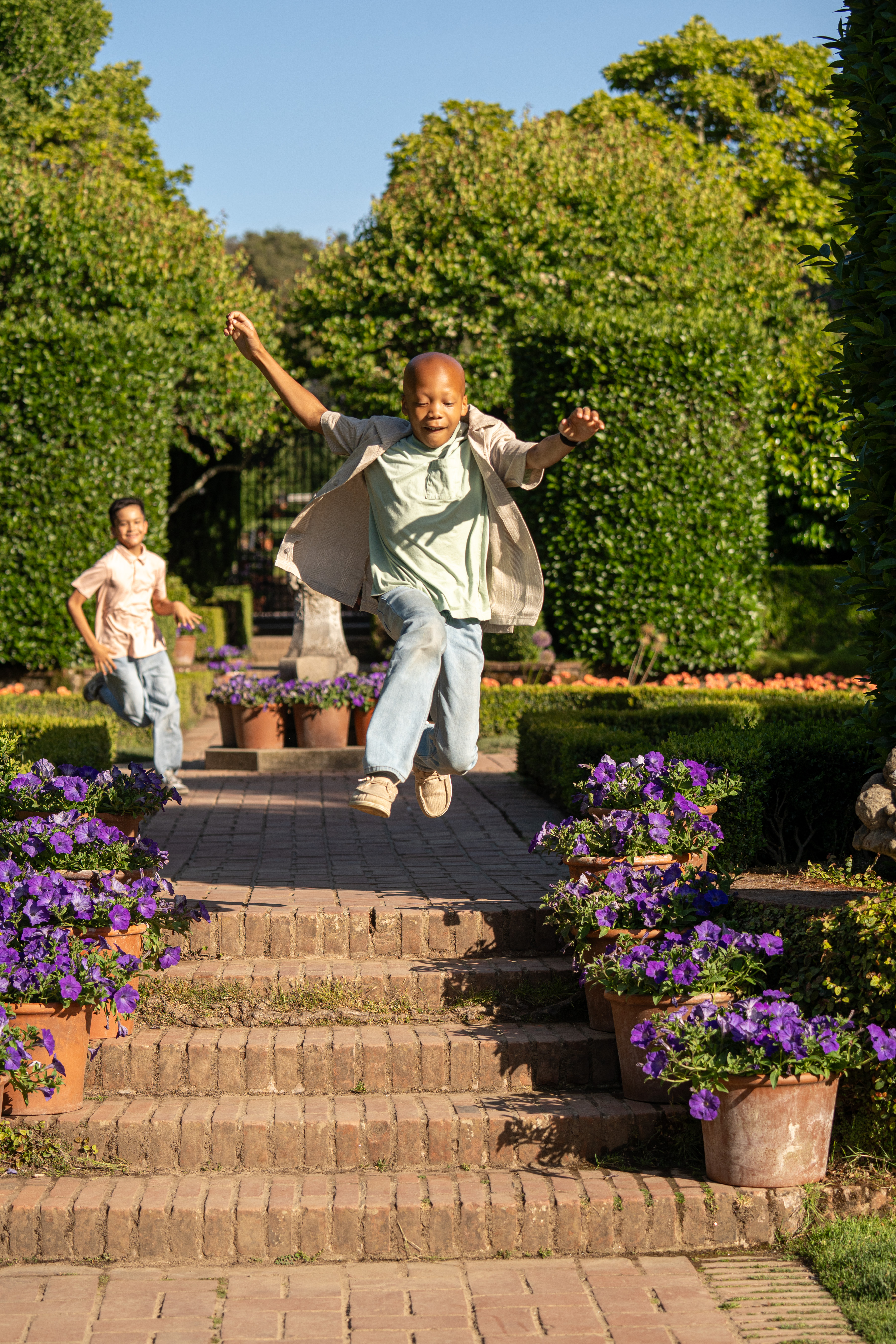 Ian leaping down steps, being chased by a kid